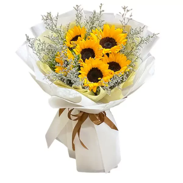 Bouquet of sunflowers and filler flowers in white and yellow wrapping paper, tied with a brown ribbon.