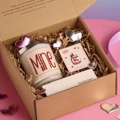 Gift box with a "Mine" candle, heart pins, and a "Happy" card.