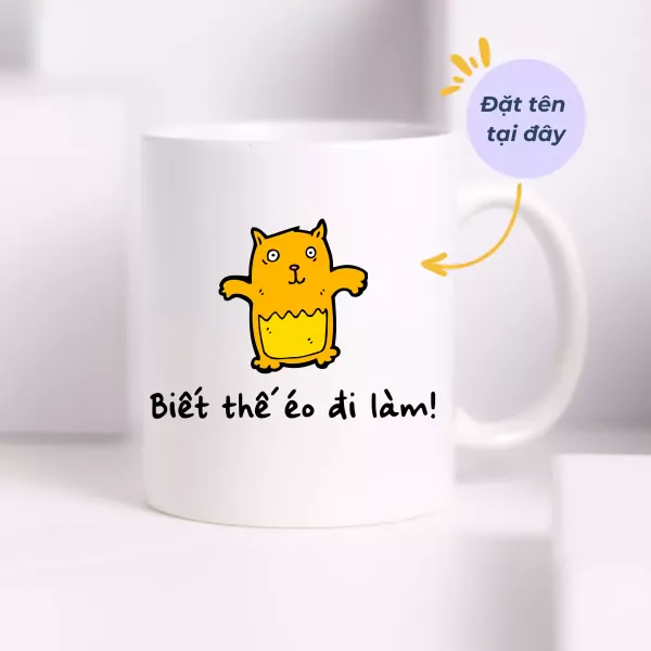 White mug with a cartoon cat and Vietnamese text "Biết thế éo đi làm!".