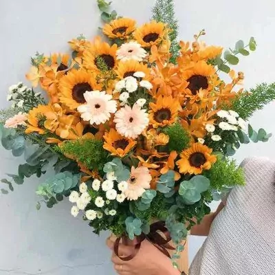 Beautiful wooden box with sunflowers, gerbera daisies, orchids, and eucalyptus.