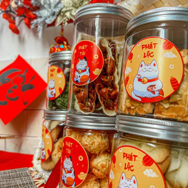 Jars of Tết treats featuring lucky cats and Vietnamese New Year motifs.